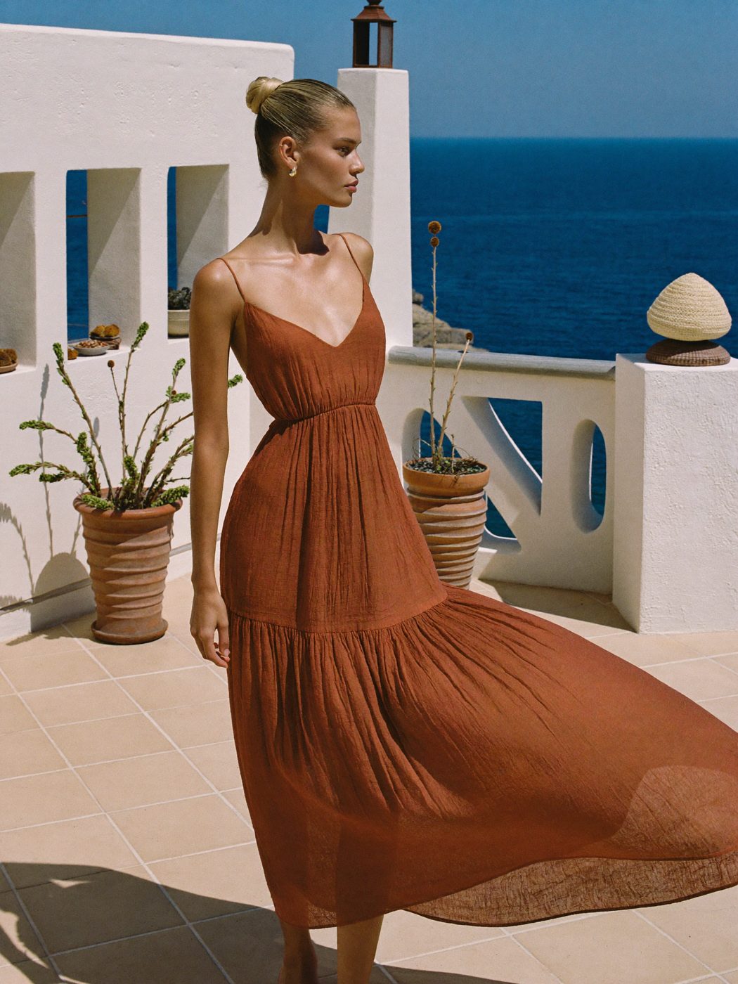 Terracotta linen dress on a Mediterranean terrace